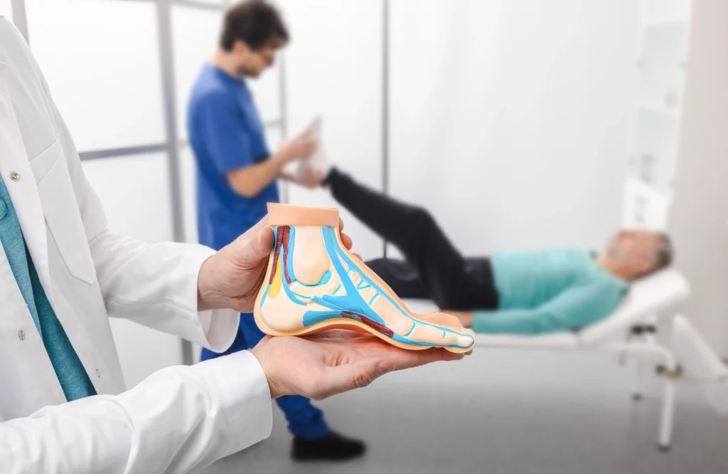 Podiatrist giving foot treatment to patient at integrity foot and ankle