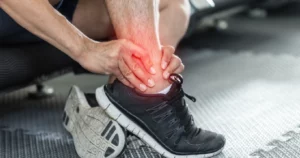 Man holding his Ankle Sprains pain in Lorain, OH .